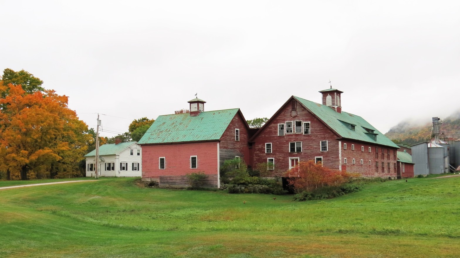 An old read barn and farmhouse in autumn in Maine